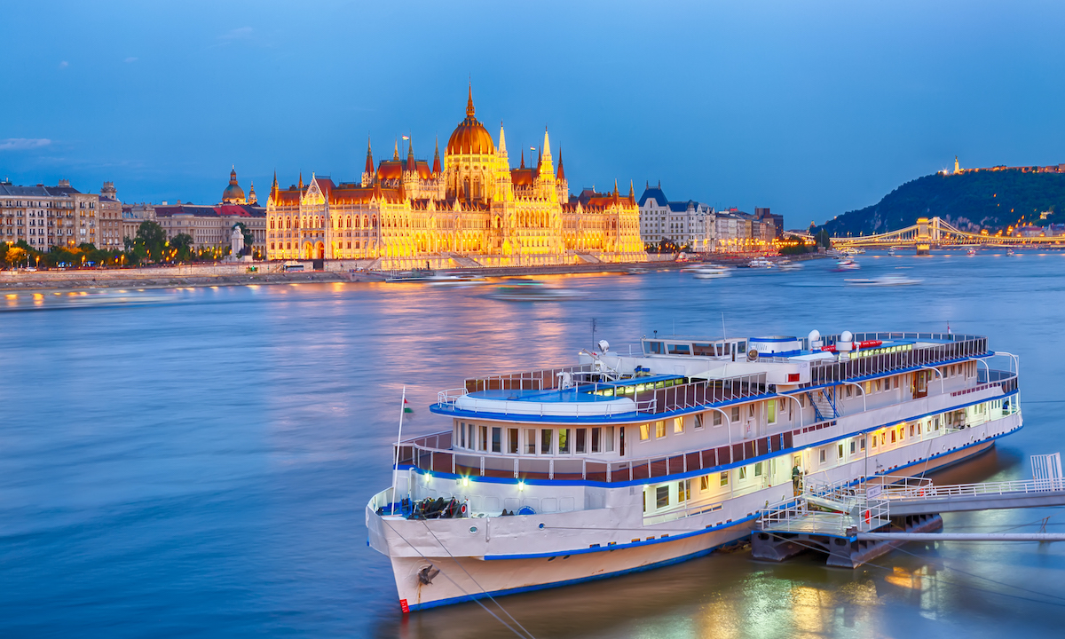 Travel and european tourism concept. Parliament and riverside in Budapest Hungary with during blue hour sunset